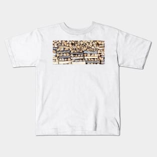 Chopped wood piled in a wood stack Kids T-Shirt